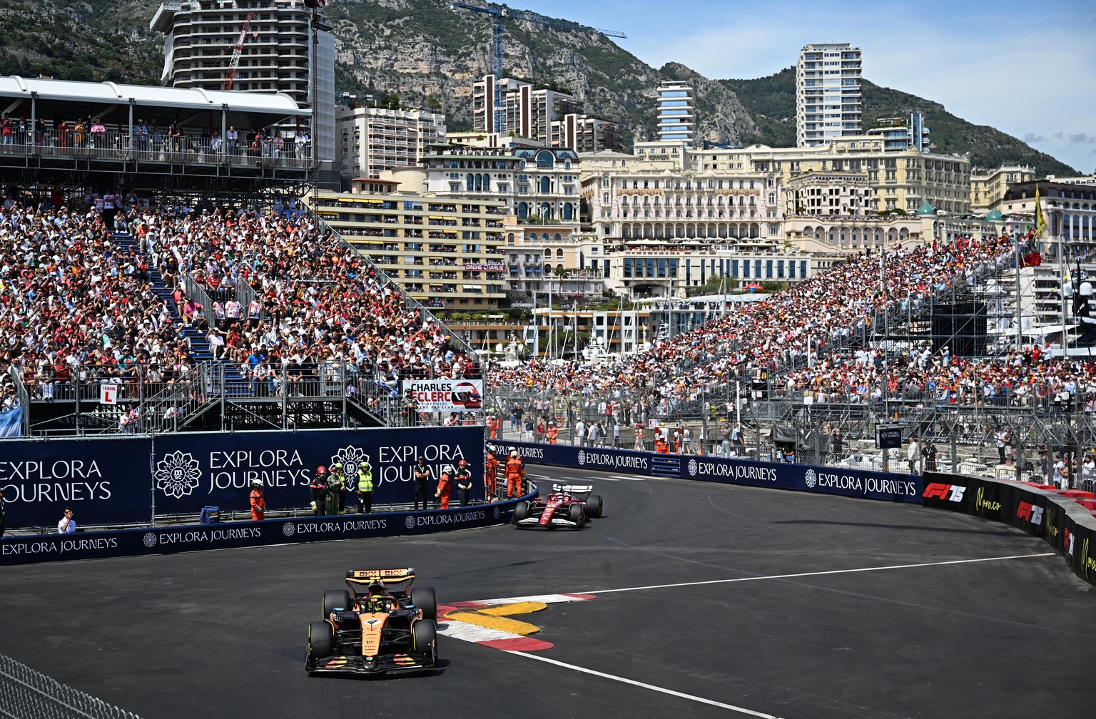 epa12133790 McLaren driver Lando Norris (front) of Britain leads Scuderia Ferrari driver Charles Leclerc of Monaco during the Formula One Grand Prix of Monaco at the Circuit de Monaco in Monte Carlo,  ...