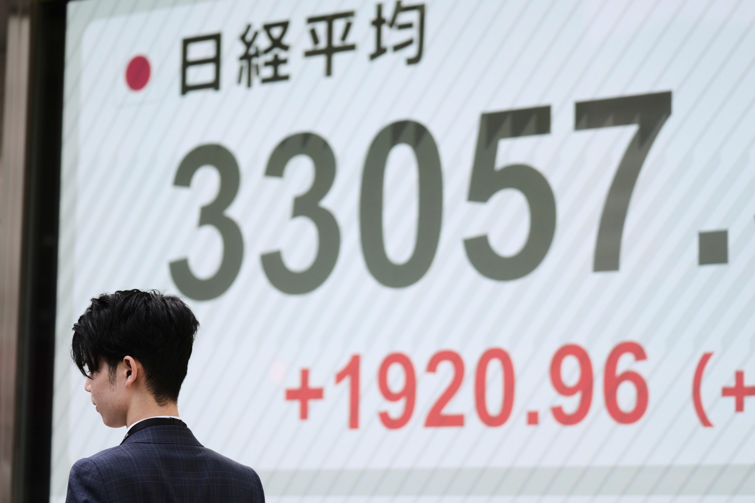 A man walks by monitors showing Japan&#039;s Nikkei 225 index at a securities firm in Tokyo, Tuesday, April 8, 2025. (AP Photo/Hiro Komae)
Japan Financial Markets